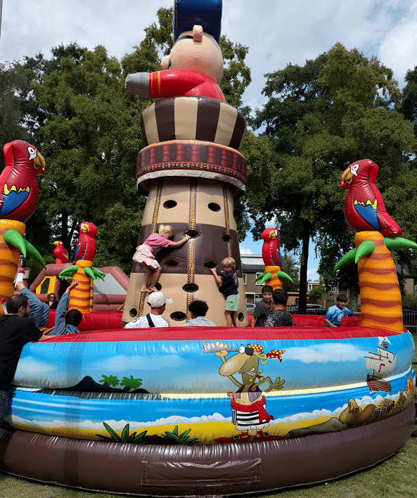 Kinderen spelen op een groot luchtkussen in de vorm van een pirateneiland